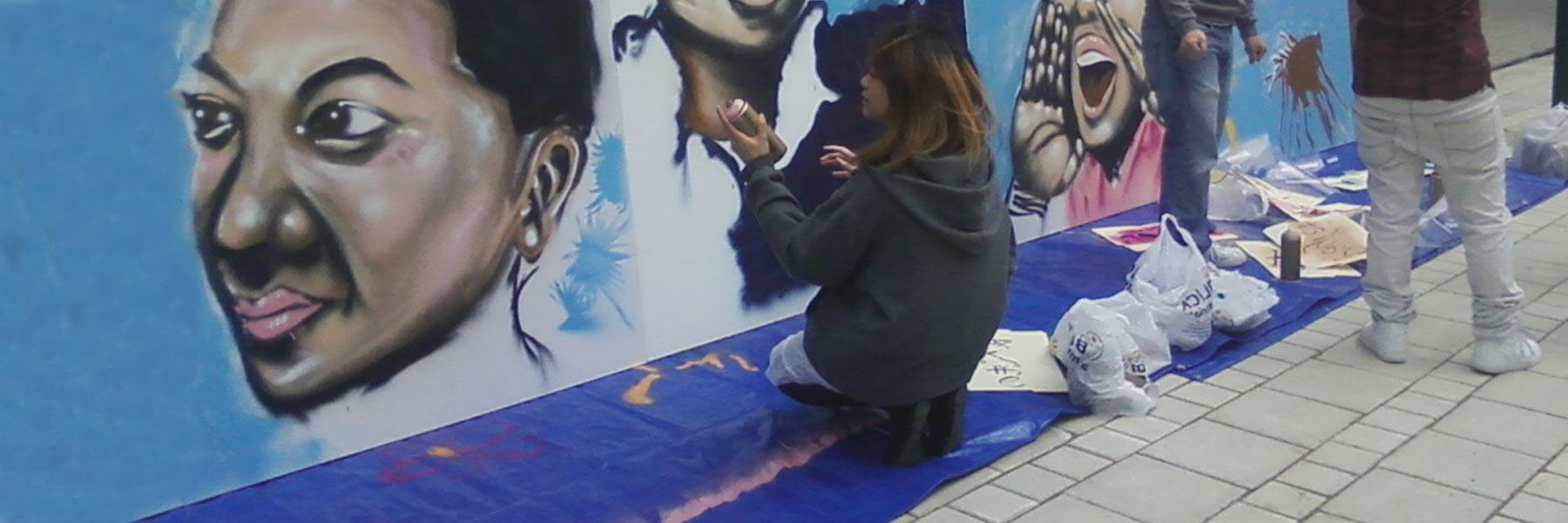 young asian people painting mural